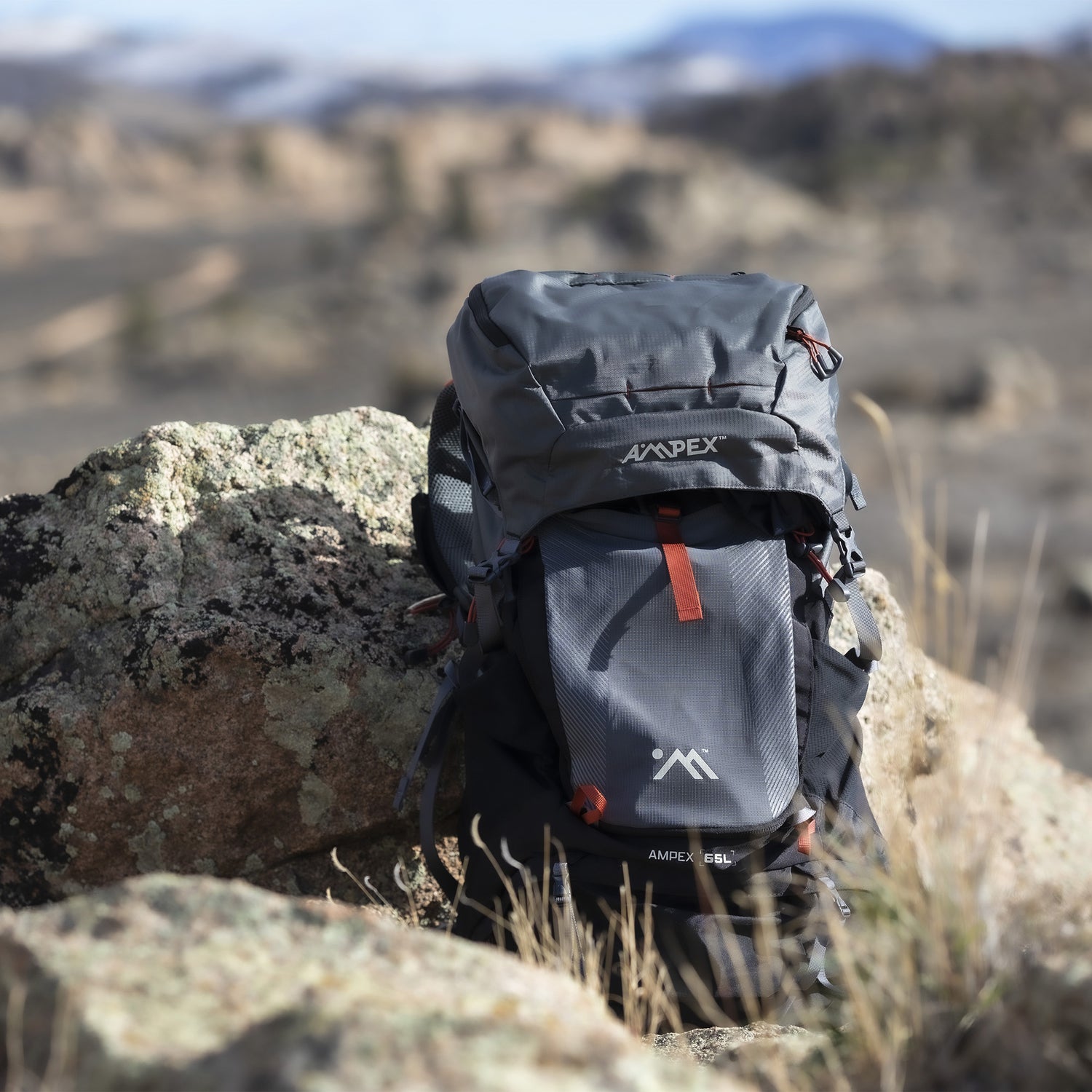 Backpack placed on rocks in a rugged outdoor landscape.