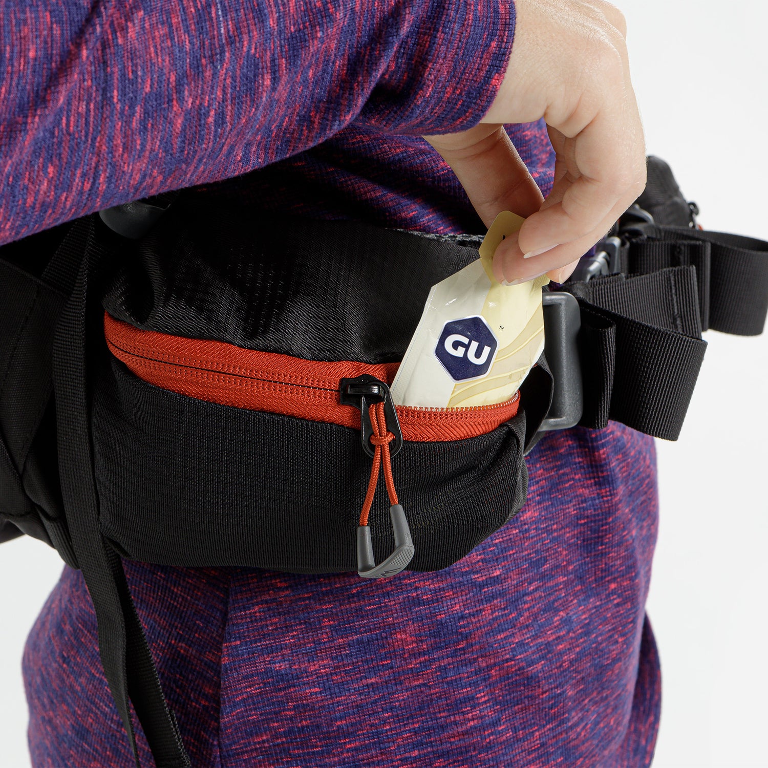 Close-up of hip belt zip pocket with energy gel packet inside.