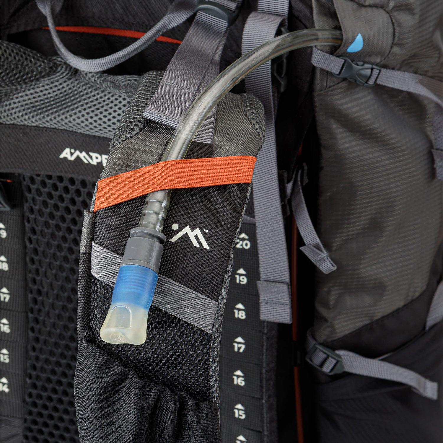 Camelback hose clipped into the strap of the backpack.