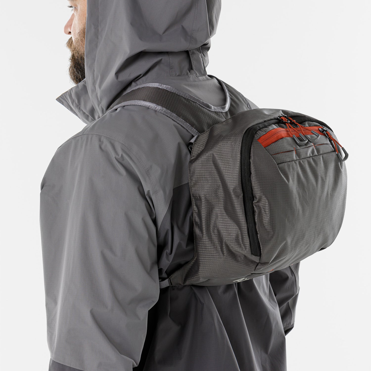 Person carrying the backpack’s removable top lid pouch over their shoulder like a sling bag.