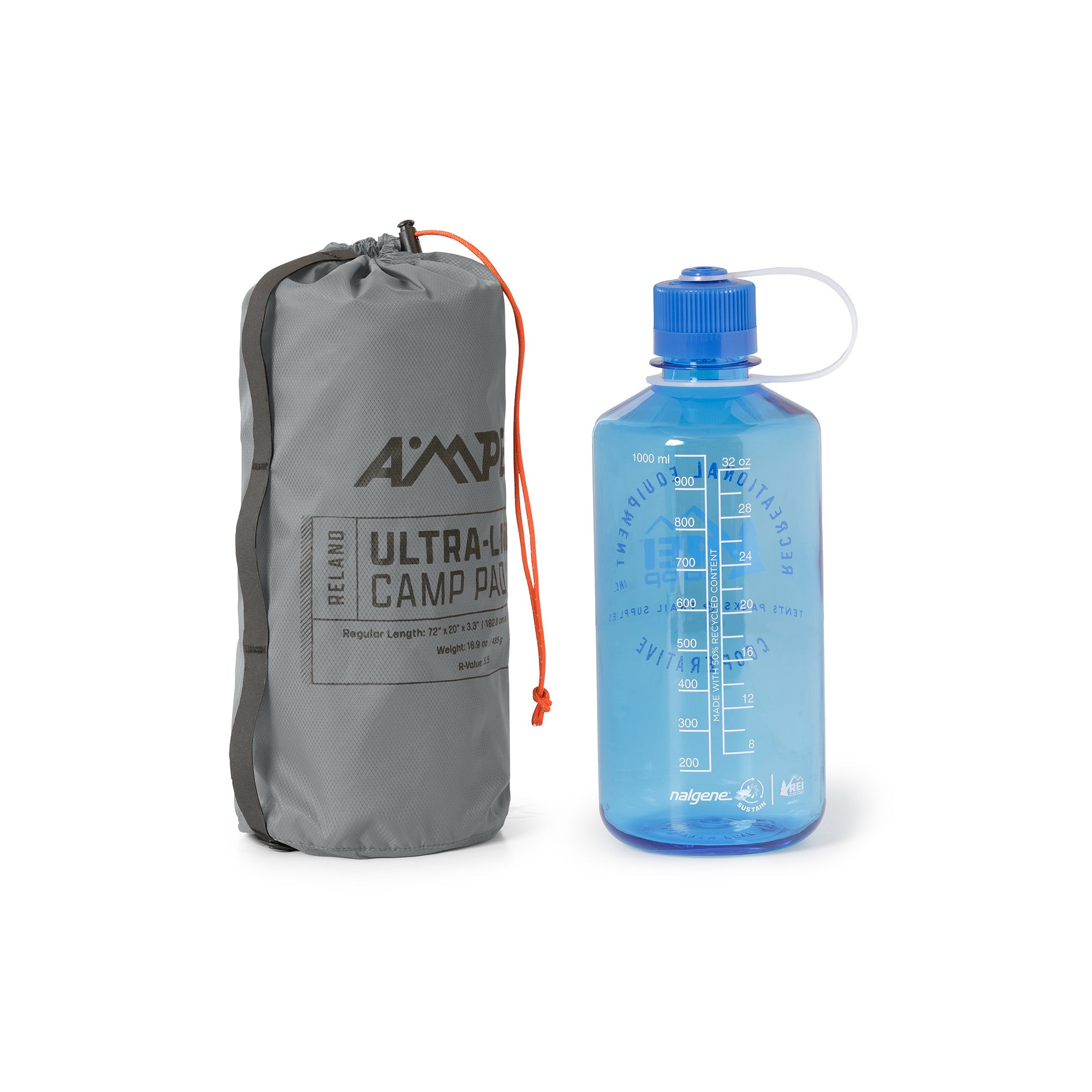 Ampex sleeping pad rolled and packed into a tall gray storage sack, shown next to a blue water bottle for size comparison.