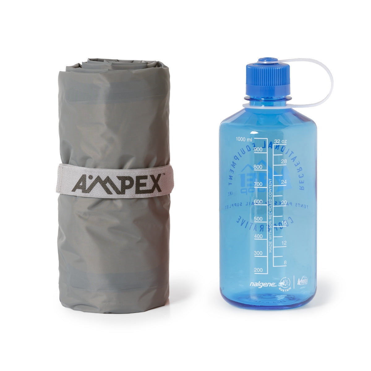 Ampex sleeping pad rolled, shown next to a blue water bottle for size comparison.