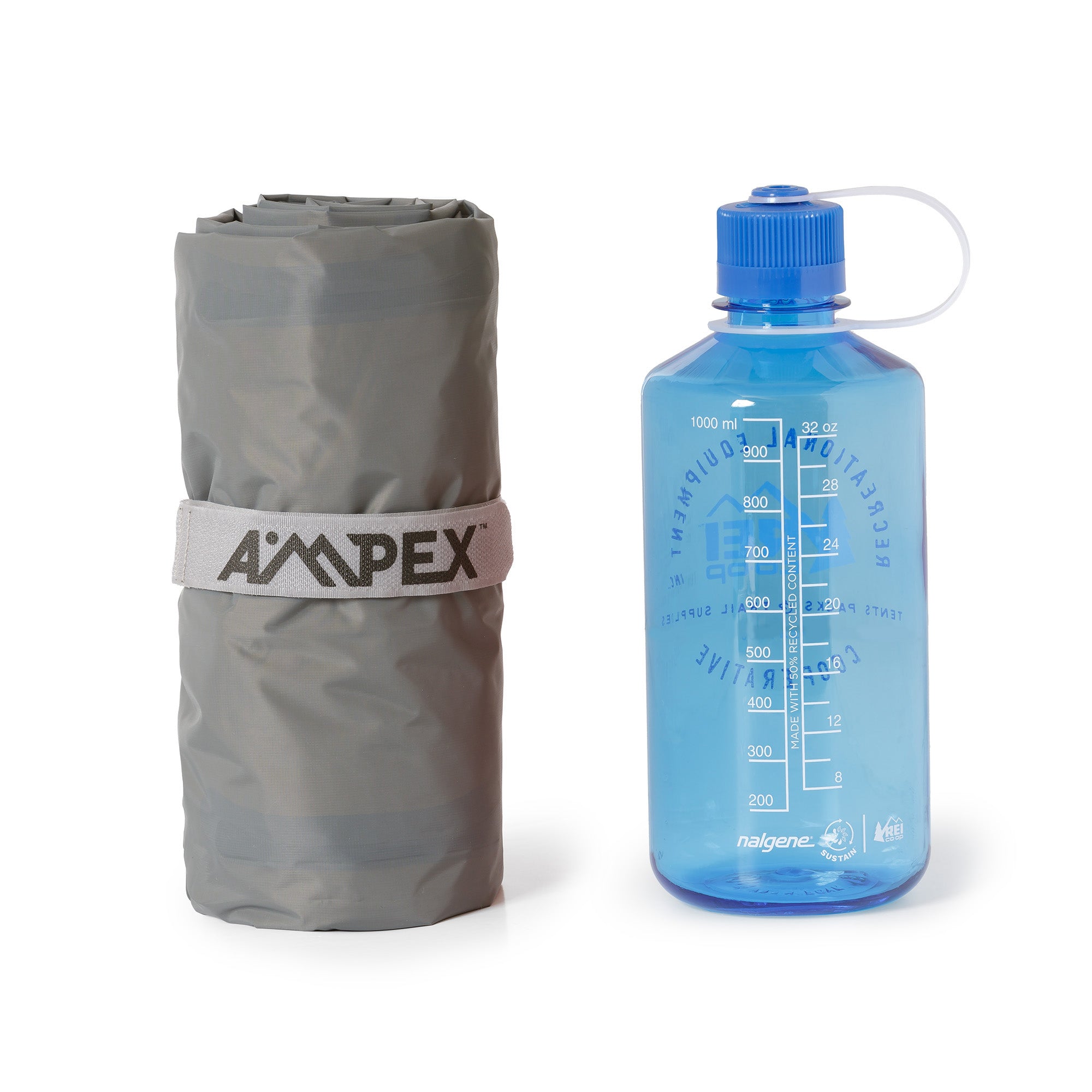 Ampex sleeping pad rolled, shown next to a blue water bottle for size comparison.