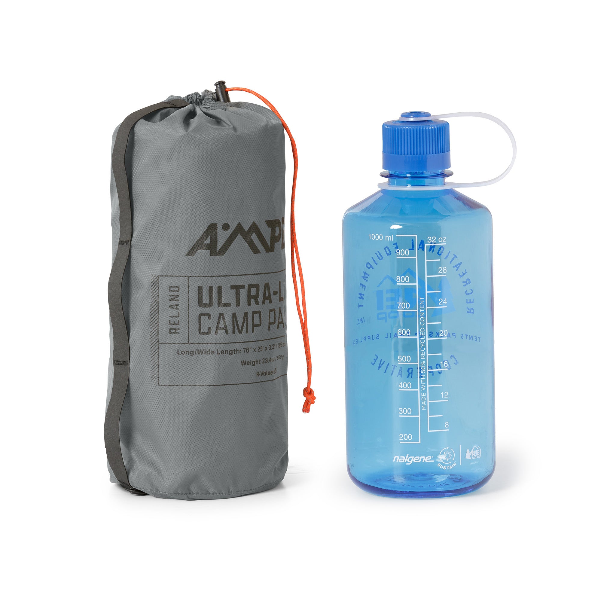 Ampex sleeping pad rolled and packed into a tall gray storage sack, shown next to a blue water bottle for size comparison.