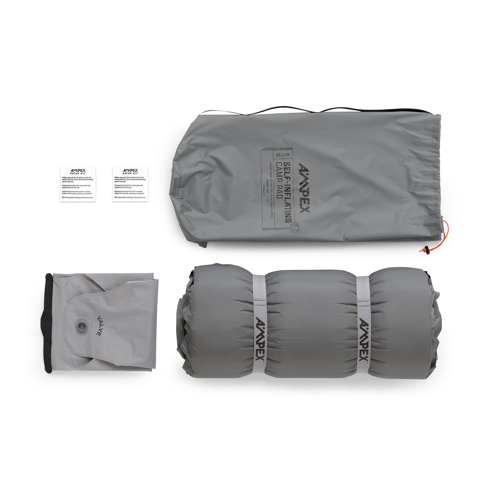 Sleeping pad with included accessories laid out—gray storage bag, patch kit pouch, pump sack, and pad.