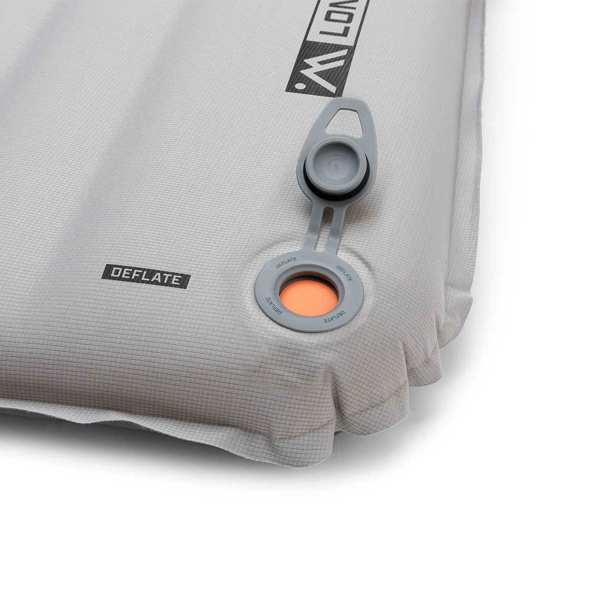 Close-up of the sleeping pad showing the valve open with orange interior visible for airflow release.