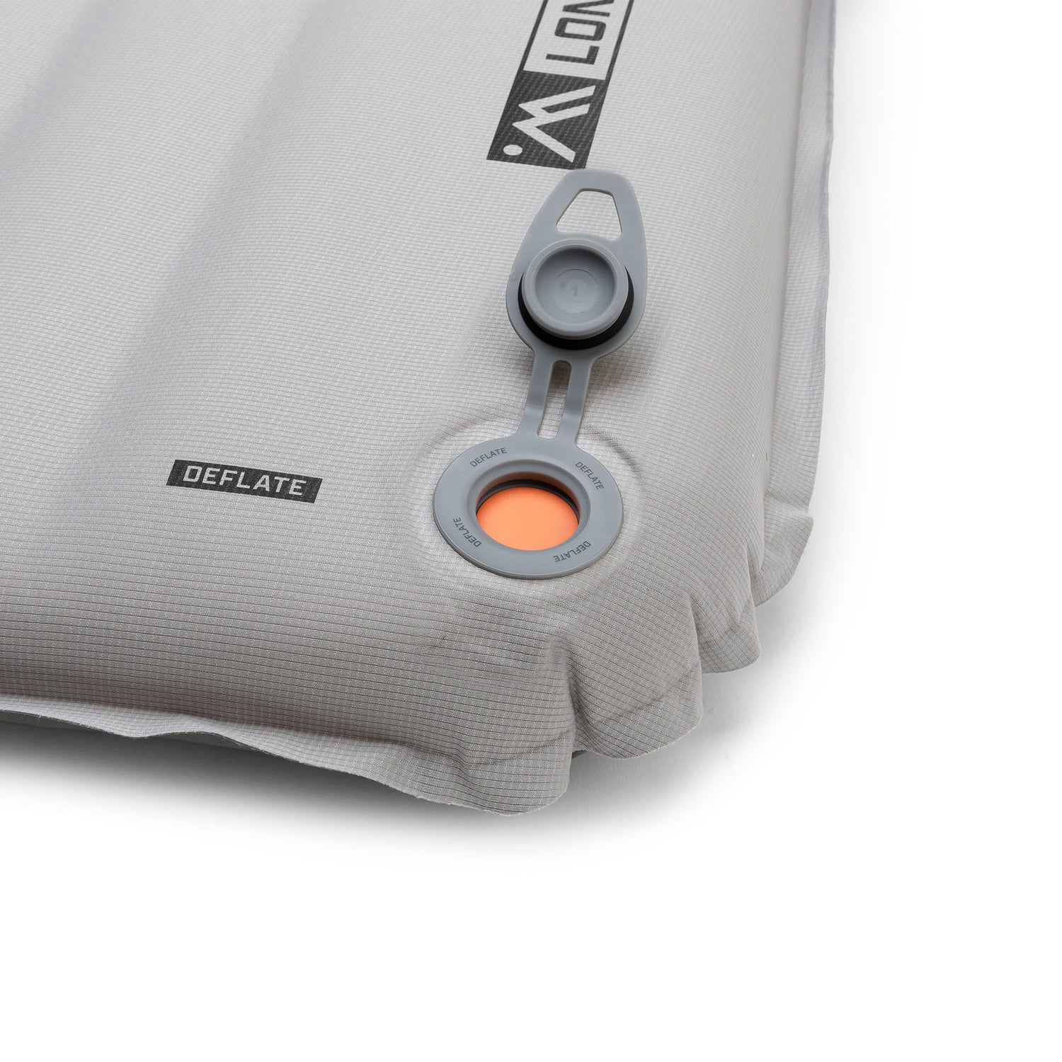 Close-up of the sleeping pad showing the valve open with orange interior visible for airflow release.