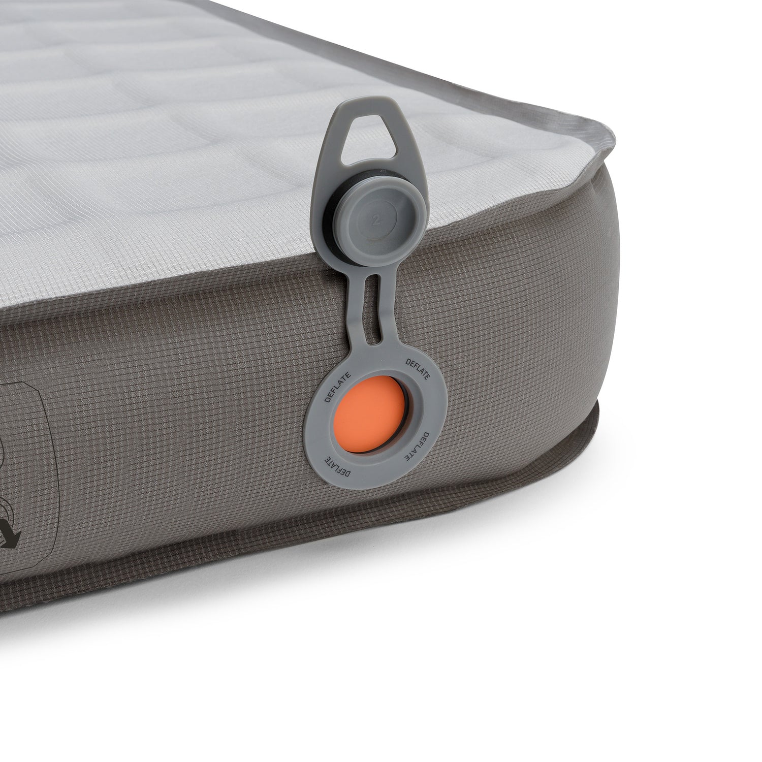 Close-up of the pad’s side corner with deflation valve, textured fabric, and printed instructions.