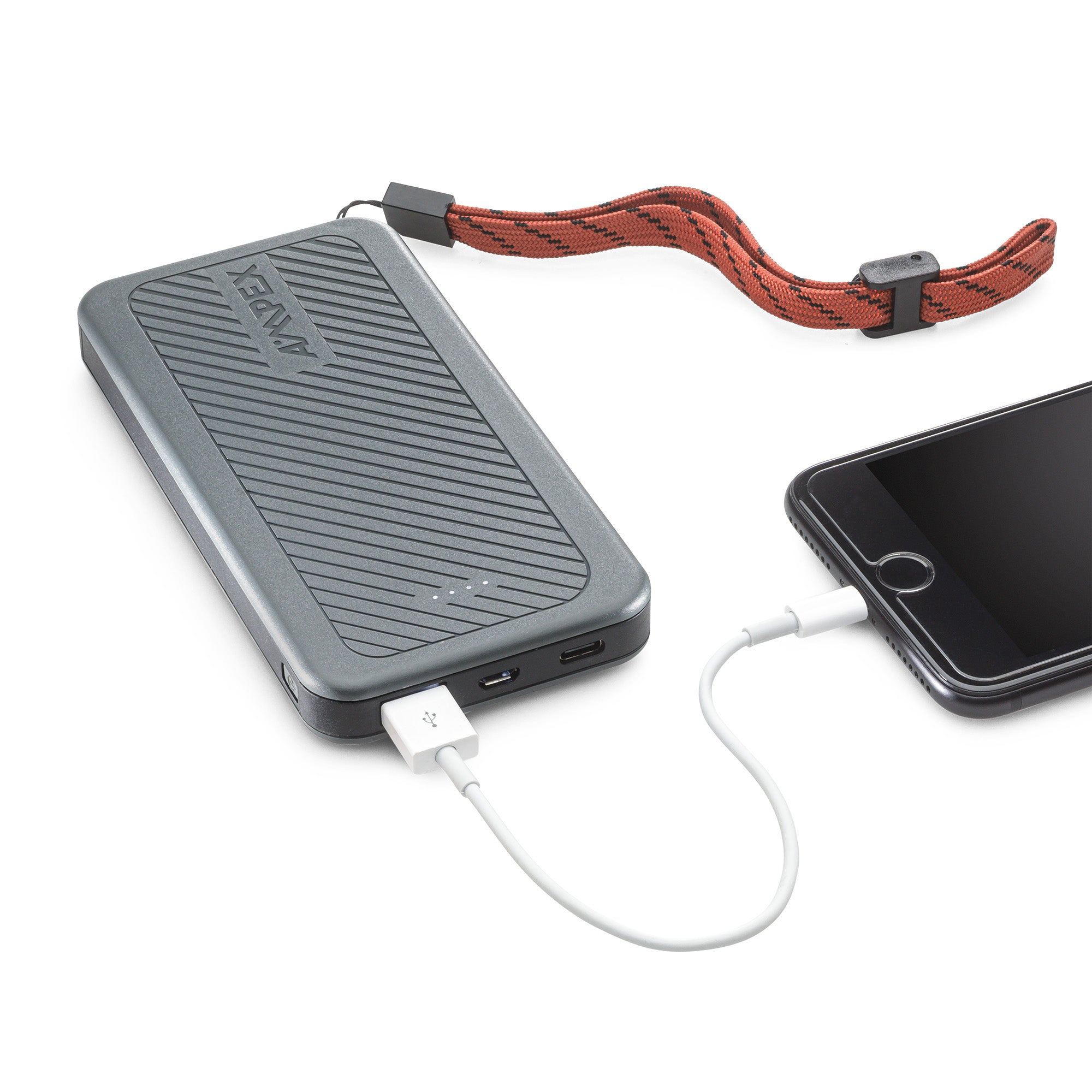 Close-up of Power Bank charging a phone with a USB cable.