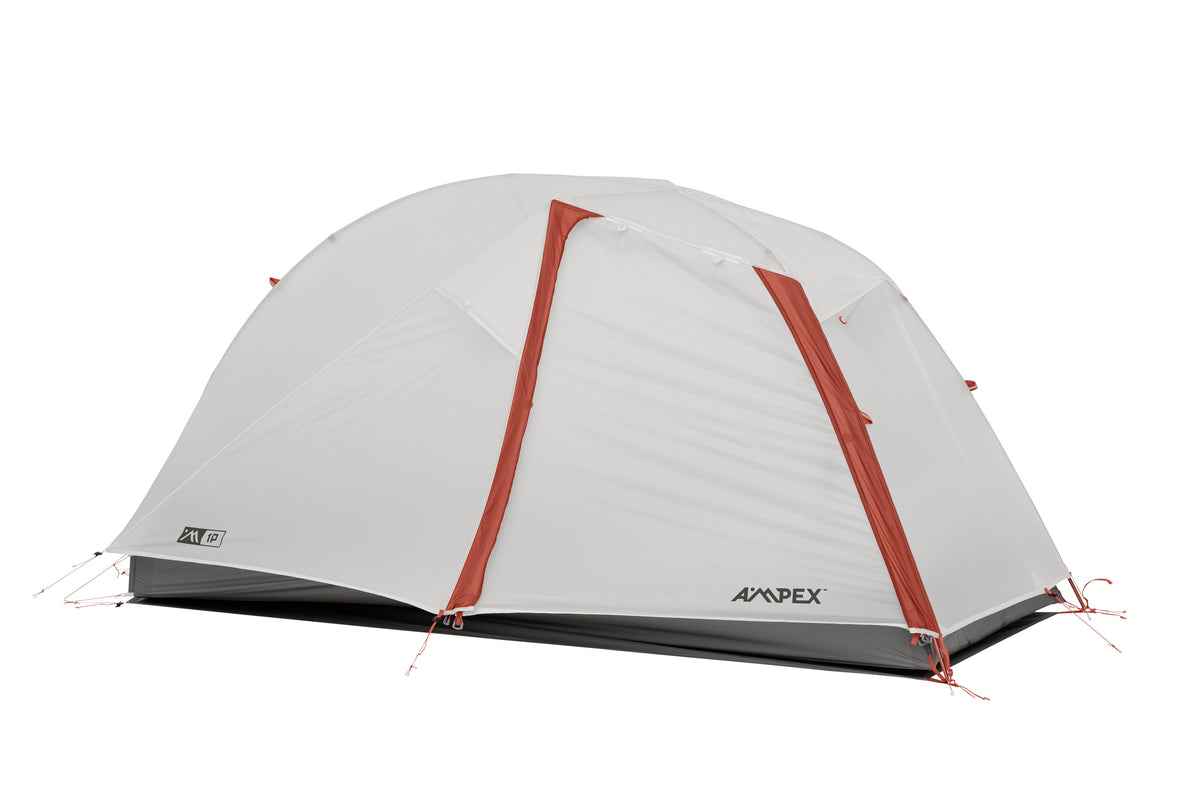 Tent with gray rainfly fully covering canopy, red trim visible.