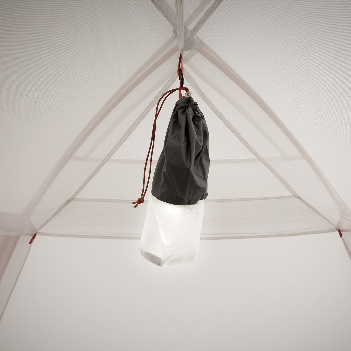 Close-up of ceiling area with a black and white gear sack hanging from an interior loop.